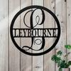 Decorative metal sign with 'LEYBOURNE' on a wooden background