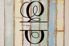 Decorative split letter monogram "E" on a rustic wooden background