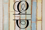 Decorative split letter monogram "E" on a rustic wooden background