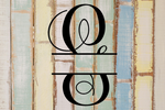 Decorative split letter monogram 'G' on a rustic wooden background with pastel colors.