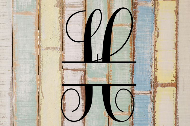 Decorative split letter monogram 'H' on a wooden background with a rustic finish.