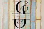 Decorative split letter monogram 'I' on a rustic wooden background with pastel colors.