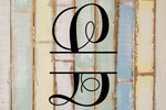 Split letter monogram 'L' on a wooden background with a rustic finish.