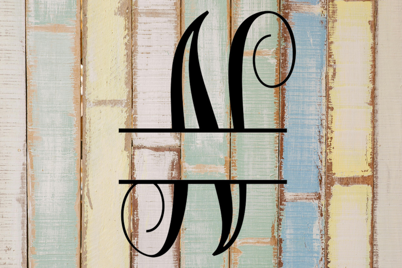 Decorative split letter monogram 'N' on a textured wooden background with pastel colors.