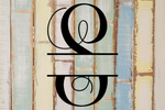 Decorative split letter monogram 'S' on a wooden background with a rustic finish.