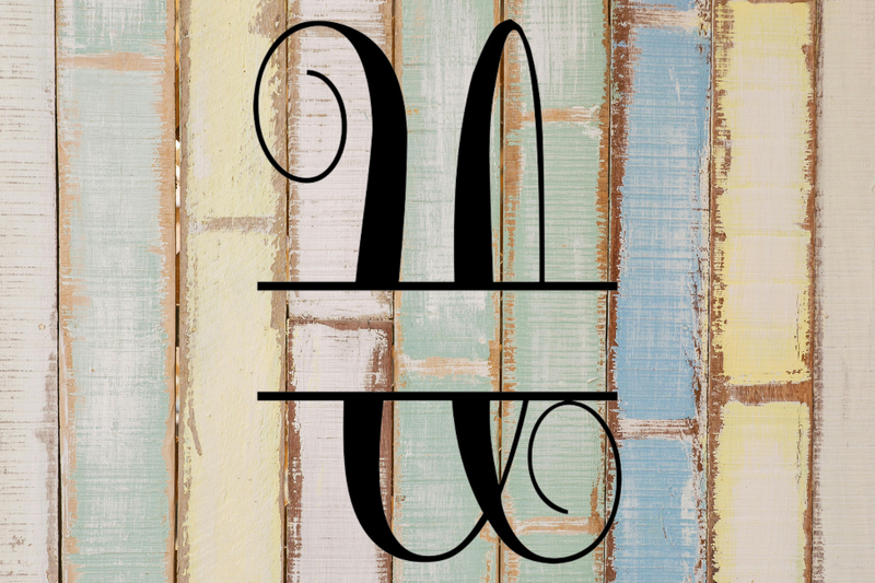 Decorative split letter monogram 'U' on a rustic wooden background with pastel colors.
