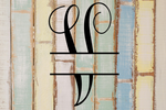 Decorative split letter monogram "V" on a rustic wooden background with pastel colours.