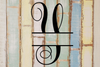 Decorative split letter monogram 'Y' on a wooden background with a rustic finish.