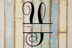 Decorative split letter monogram 'Y' on a wooden background with a rustic finish.