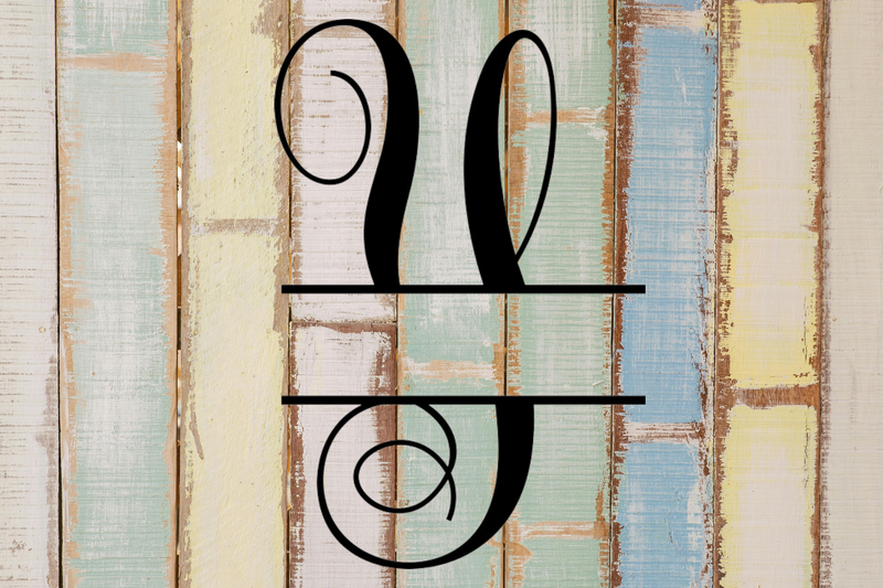 Decorative split letter monogram 'Y' on a wooden background with a rustic finish.