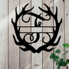 Metal sign in the shape of Antlers with a capital F and a space for a custom name.