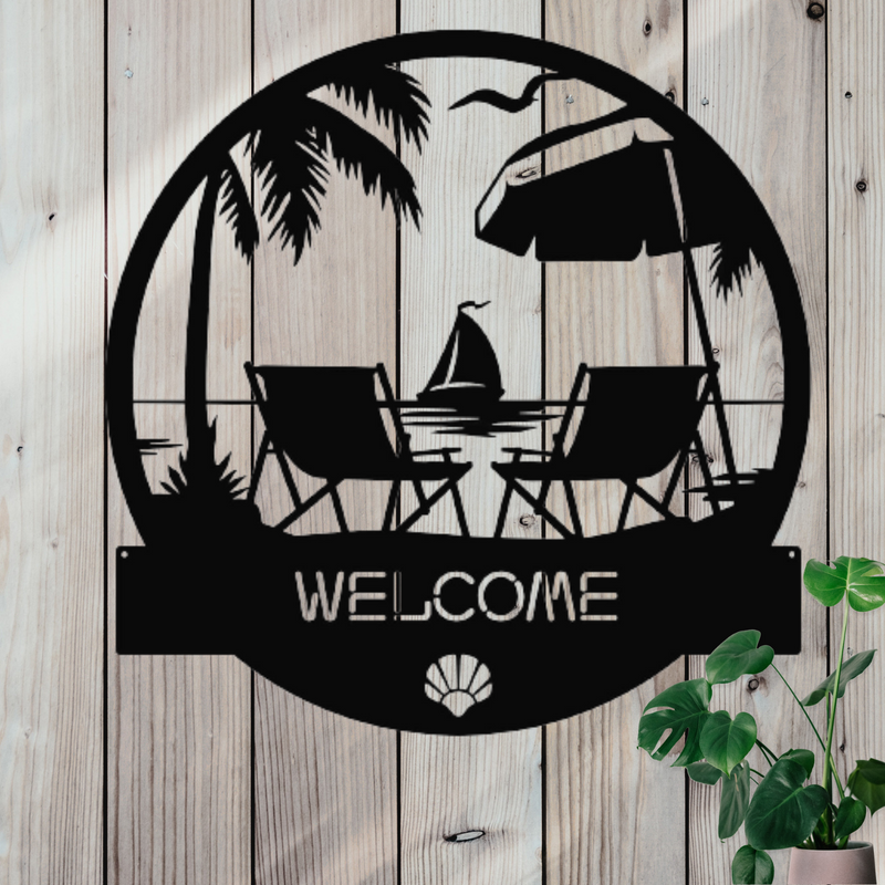 Round black metal sign of beach chairs, sailboat & palm trees with the word welcome across the bottom