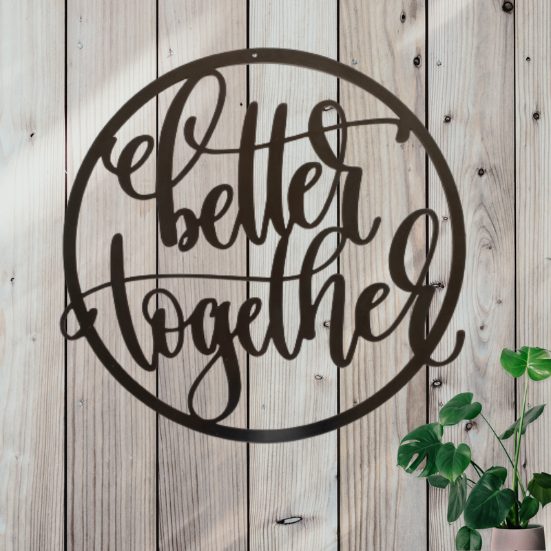 Black circular metal sign with the words better together in cursive writing.