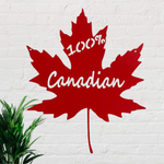 Red metal sign in the shape of a maple Leaf with the words 100% Canadian cut out of it