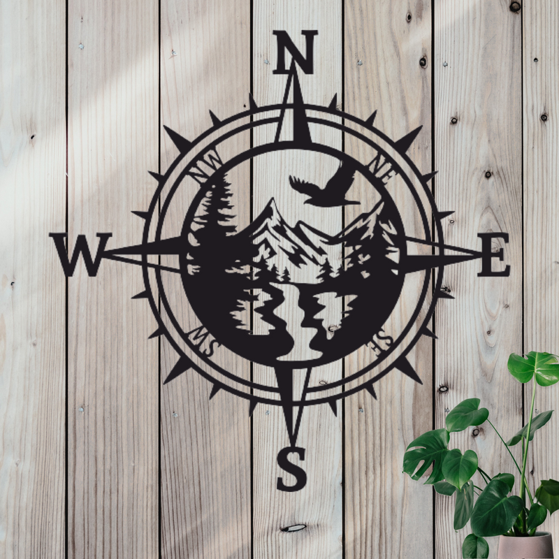 Compass decor with a mountain nature scene in the middle. 